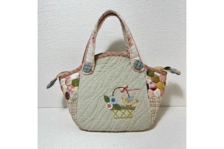 Hexagonal patchwork crossbody bag with appliqué